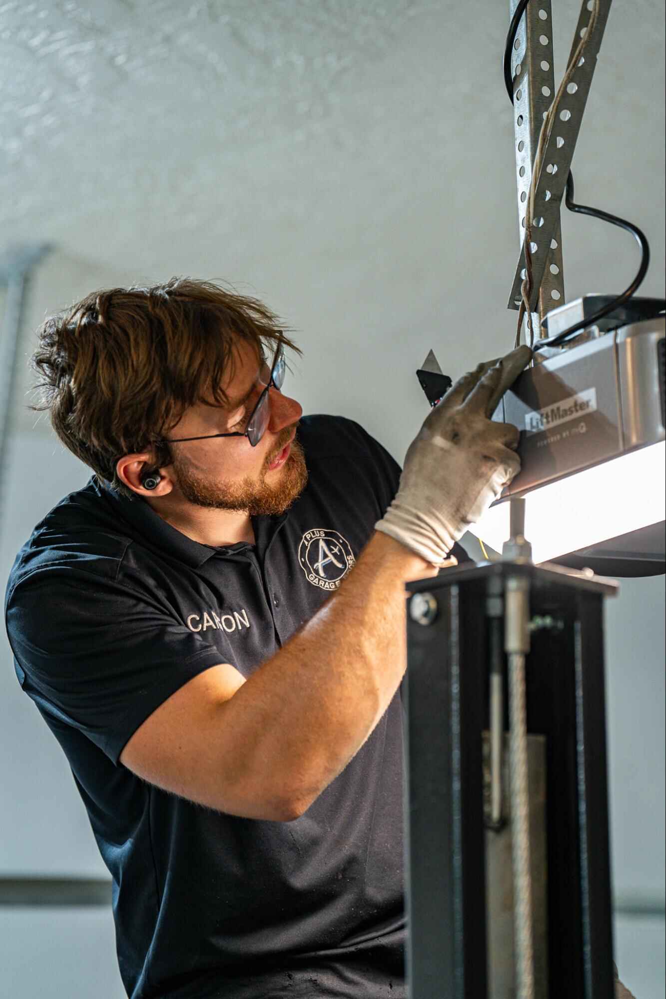 Toni's Garage Doors technician repairing a garage door